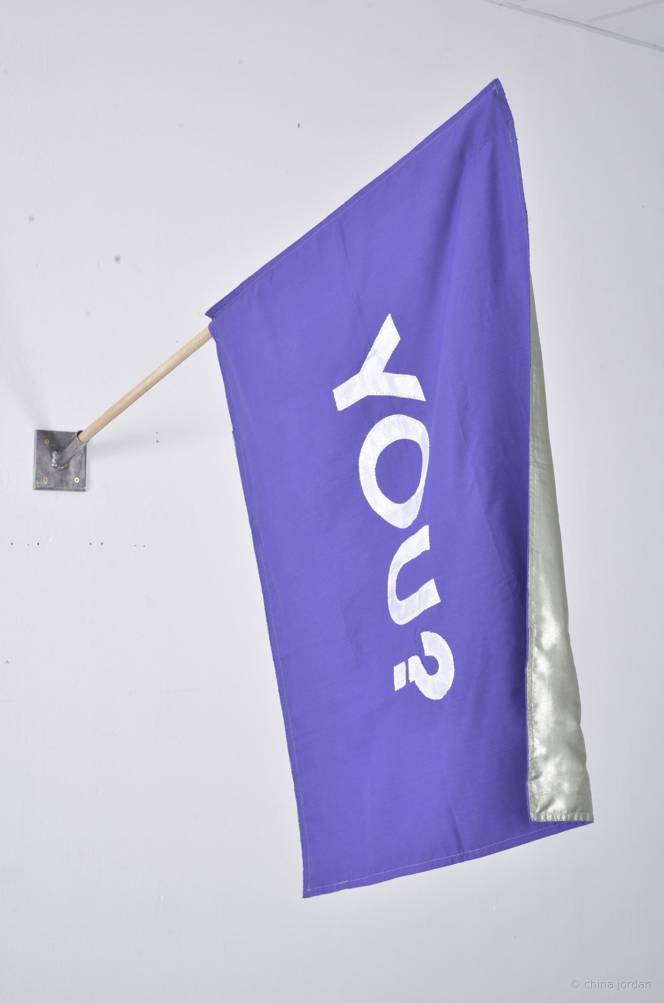 YOU? — appliqu&eacute;d purple fabric flag on wooden pole